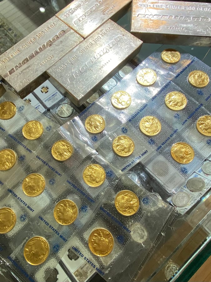 Gold coins and bullion displayed in a retail case